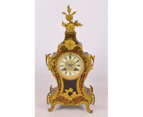 A late 19th century French Boullework eight day mantel clock, the shaped case with foliate scroll mounts, the circular dial s