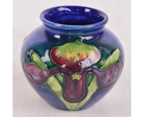 A small Moorcroft vase decorated in the Orchid pattern, impressed marks to base, height 7cm. 