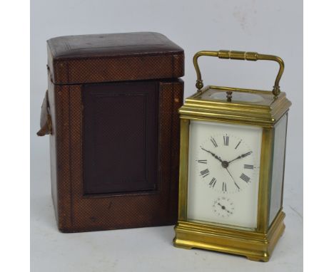 A late 19th century French brass repeating carriage clock with swing loop handle above rectangular white enamel dial with Rom