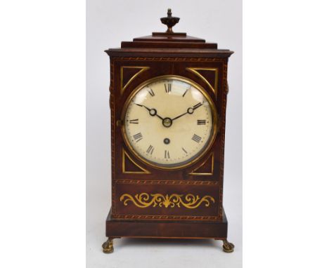 A Regency mahogany, brass and boxwood inlaid bracket clock, the circular white enamel dial set with Roman numerals housing a 