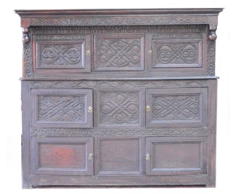 A large 17th century oak court cupboard, the moulded cornice above carved frieze inscribed "Edward Standley 1687", with turne