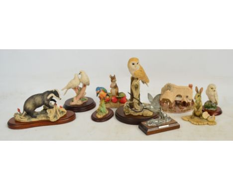 A collection of Russell Willis ceramic figures of animals, mainly on turned wooden bases, also a cottage and a pewter figure 