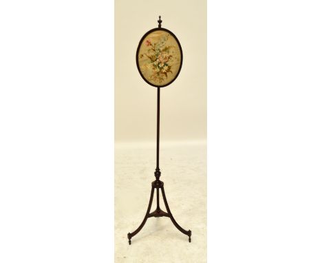 A Regency mahogany pole screen, the oval floral silk embroidered panel above turned central column to three square section ou
