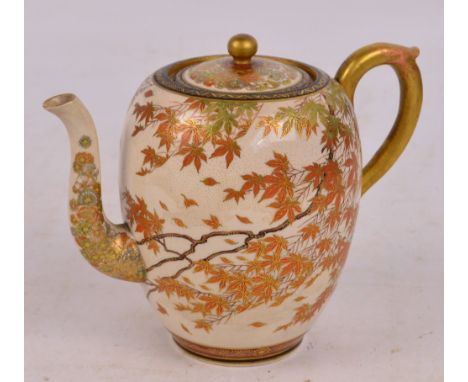 A Japanese Meiji period Satsuma teapot decorated with gilt heightened falling autumnal leaves with florally decorated spout a