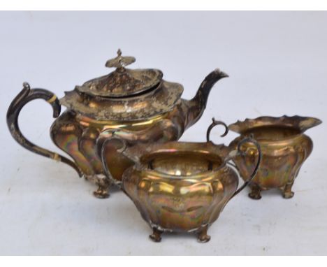 An Edwardian hallmarked silver three piece tea service of lobed form, each piece with lion rampant engraved armorial, Walker 