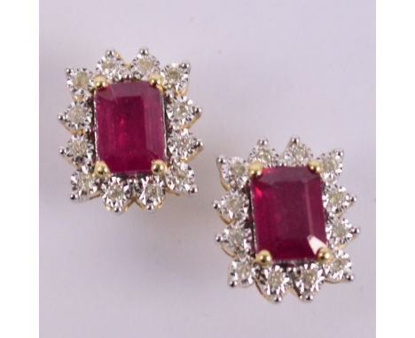 A pair of 9ct yellow gold diamond and ruby ear studs, each with central ruby within a stepped border of twelve diamonds with 