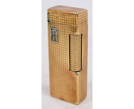 A Dunhill 9ct gold encased lighter with applied white metal initials "TG" in rectangular cartouche, no.1857352, marked to bas