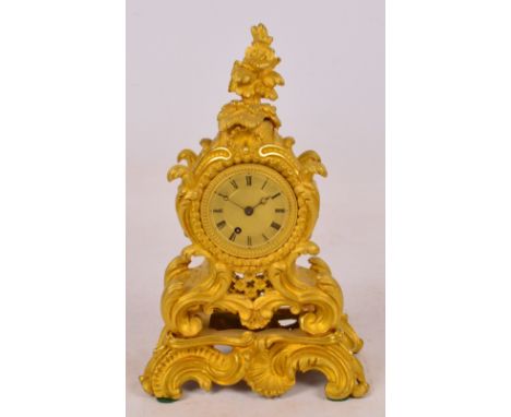 A 19th century ormolu mantel clock, the well detailed foliate scroll case centred with a circular dial set with Roman numeral