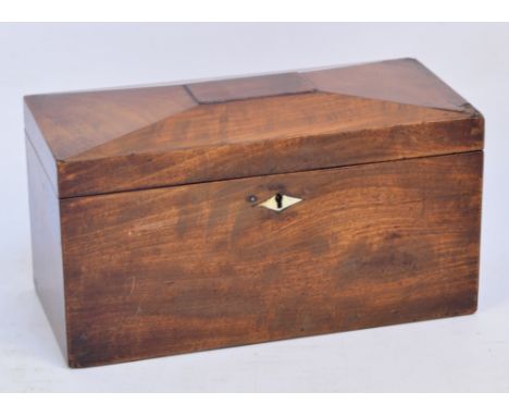 An early Victorian mahogany tea caddy of rectangular form with panelled hinged lid enclosing three lidded compartments, with 