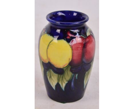 A small Moorcroft vase decorated in the Wisteria and Fruit pattern, impressed marks to base, height 8.5cm.