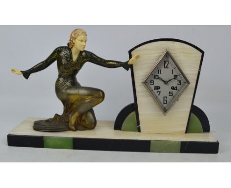 A French Art Deco marble onyx cold painted spelter and ivorine mantel clock, the lozenge shaped dial set with Arabic numerals