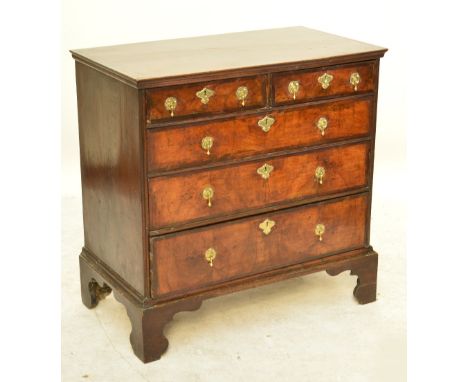 An 18th century walnut chest of drawers, the rectangular top above two short and three long crossbanded drawers with split pi