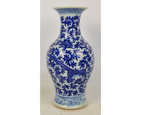 A late 19th/early 20th century Chinese vase of baluster form with flared rim, painted in underglaze blue with foliate scrolls