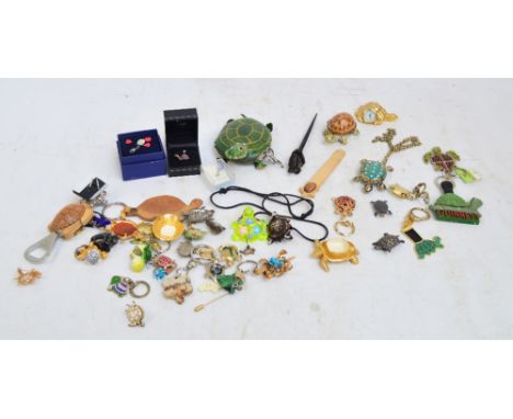 A small collection of costume jewellery modeled as tortoises to include brooches, pendants, ear studs, also various keyrings,