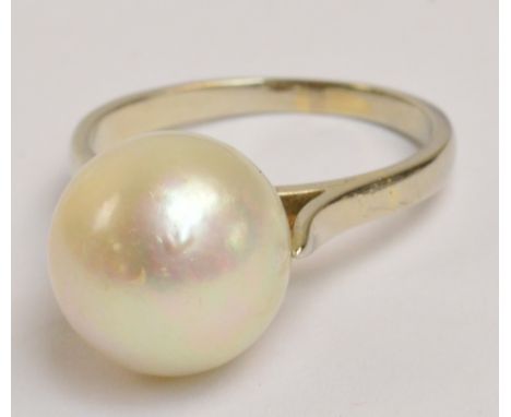 A white metal single pearl set ring, diameter of pearl approx 1.1cm, size K/L.