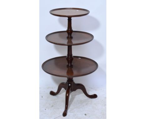 A reproduction mahogany three tier dumb waiter raised on tripod cabriole legs, height 102cm.