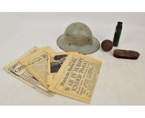 A WWII tin helmet with removable internal webbing inscribed "TSM Co Ltd 1941", also a shell casing impressed "057 BM89", a sm