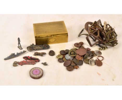 A collection of various metal detector finds to include buckles, buttons, and an enamel decorated compact.