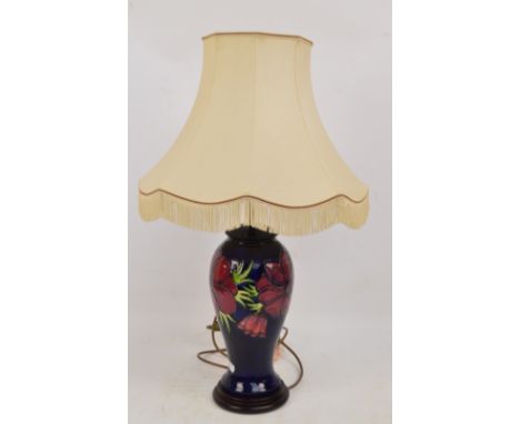 A modern Moorcroft lamp base of baluster form in the "Anemone" pattern on a rich blue ground, set on a circular plinth, heigh