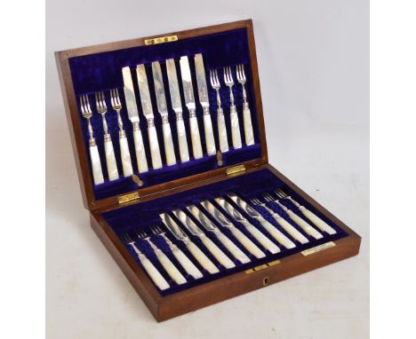 A set of twelve fruit knives and forks with Edward VII hallmarked blades, tines and collars, with mother of pearl handles, re