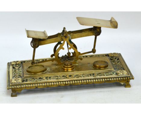 A late 19th century set of brass postal scales on rectangular bead decorated base with pierced ornamental work on four bracke