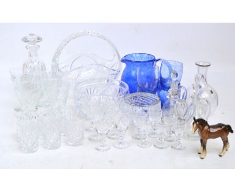 A quantity of glassware including a cut glass basket, bowl, rose bowl, a mottled blue pitcher with four tumblers, a collectio