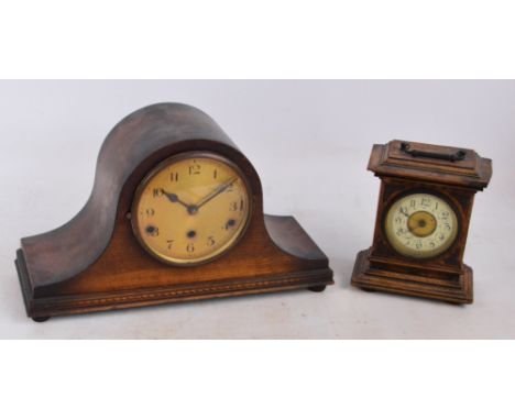 A late 19th century oak mantel timepiece with metal spandrels and carrying handle, the cream enamel decorated chapter ring se