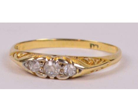 A 9ct yellow gold and diamond ring, with three graduated stones on scrolling gallery, size K/L, approx 2g.