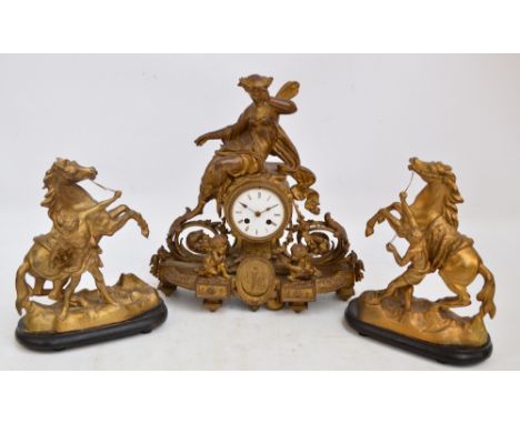 A late 19th/early 20th century gilt spelter eight day mantel clock, the cylindrical movement with enamel dial set with Roman 