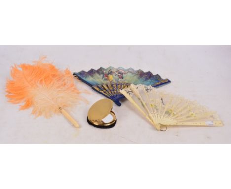 A bone and lace decorated fan, length 21cm, a further hand painted example, and an orange tinted feather fan, also a vintage 