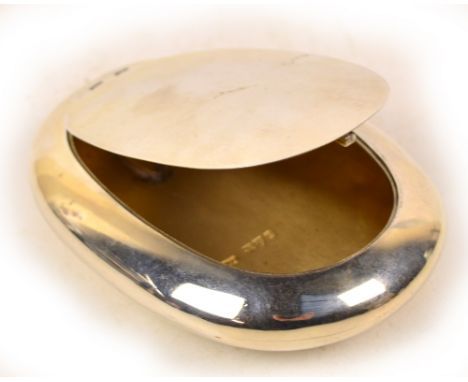 A Victorian hallmarked silver "squeeze action" snuff box of plain oval form, the flush hinged lid enclosing a gilt wash inter