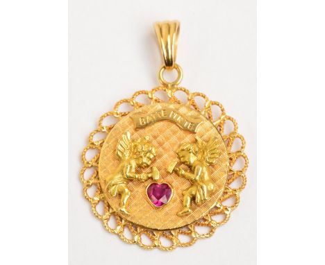 An unusual 18ct yellow gold pendant with pierced border and central engraved circular panel set with two cherubs hammering a 