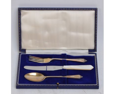 A cased Elizabeth II hallmarked silver three piece christening set comprising a spoon, fork and a mother of pearl handled sta