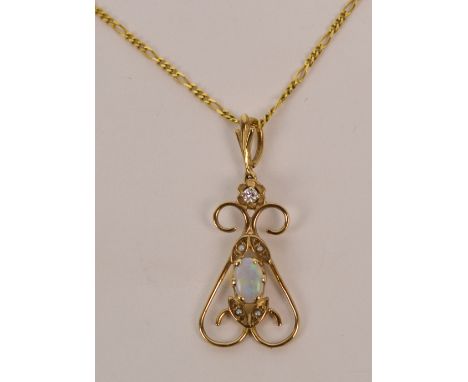 A 9ct yellow gold opal seed pearl and diamond pendant of looped pierced form with suspension ring, suspended from a 9ct yello