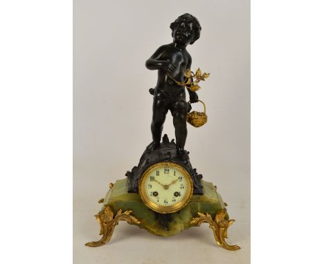 A late 19th century French mantel clock with green onyx base, the circular dial set with Arabic numerals, surmounted with a c
