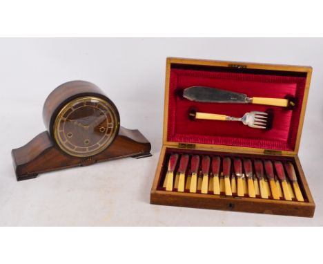 A walnut cased set of twelve fish knives, forks and servers, and a dome topped mantel clock (2).