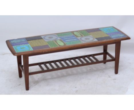 A 1960's teak tile top coffee table with undertier, 115 x 39cm.