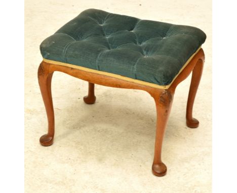 A button upholstered footstool.