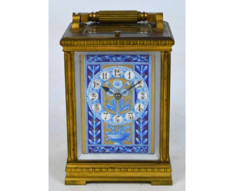 A late 19th century French half hour repeating brass carriage clock with enamel painted panels in blue and white, the front p
