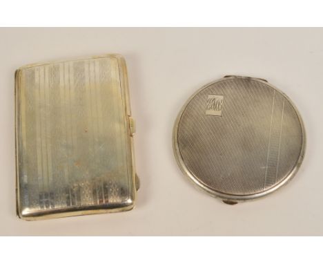 A George V hallmarked silver cigarette case of rounded rectangular form with overall engine turned decoration, centred with a