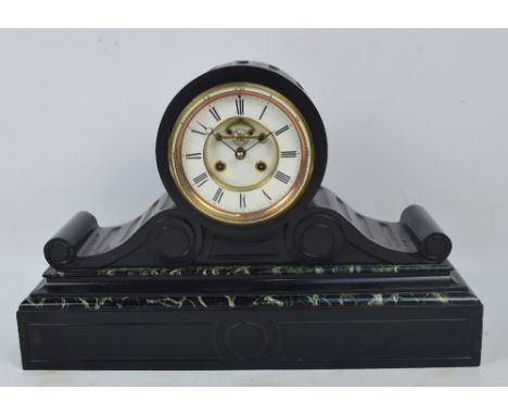 A late 19th century French black slate and green marble detailed mantel clock, the drum type case with two piece white enamel