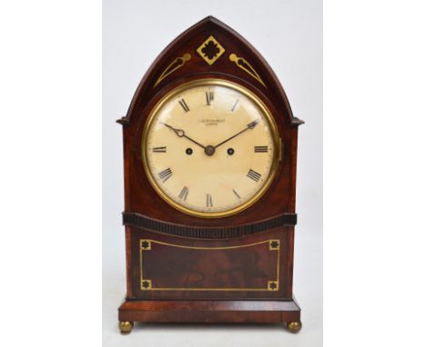 A Regency mahogany and brass inlaid bracket clock, the lancet shaped case centred with a white painted dial set with Roman nu