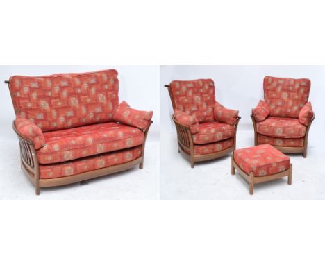 An Ercol three piece upholstered conservatory suite comprising a settee, a pair of armchairs, also a footstool, design no.E92