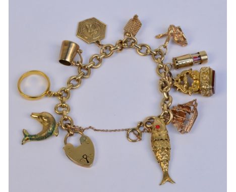 A 9ct yellow gold flat cable link chain with heart shaped padlock, suspending nine 9ct gold charms including an articulated f