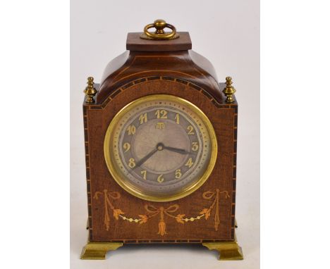 A small Edwardian mahogany and inlaid mantel clock with silvered dial set with Arabic numerals inscribed "Ato" with brass bra