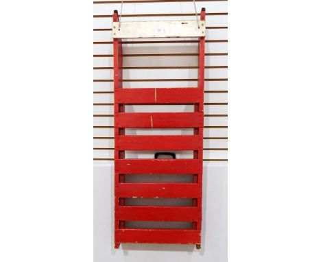 A vintage toboggan/sledge painted red with metal runners 