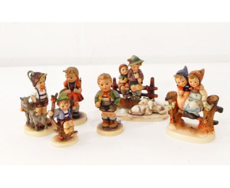 A Goebel figure group of two children seated on a fence with sheep, another similar and four other Goebel figure ornaments (6