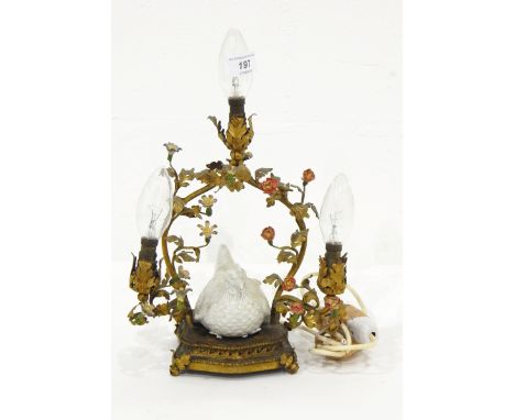 A gilt and metal table lamp, the branches decorated with painted flowers and leaves and with a ceramic chicken in the middle 