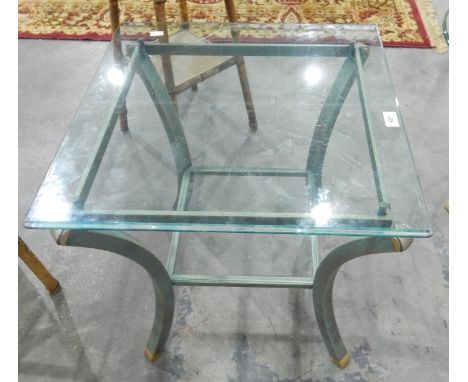 An oval metal framed glass topped two-tier lamp table 