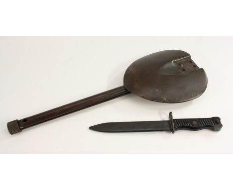 A Yugoslavian M1956 knife bayonet, for the 9mm sub machine gun, 17.5cm pointed double-edged blade, two-piece grip, steel scab